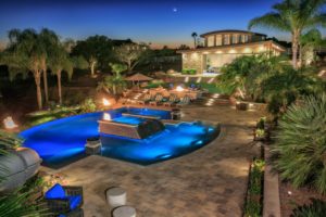 "outdoor living with large swimming pool and lighting control"