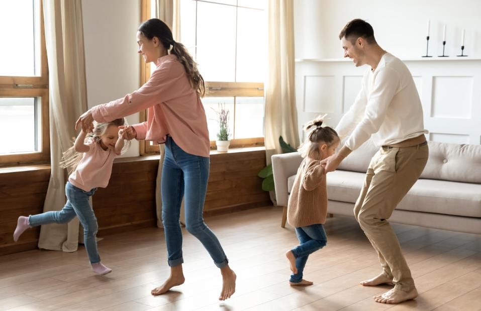 family dancing in home